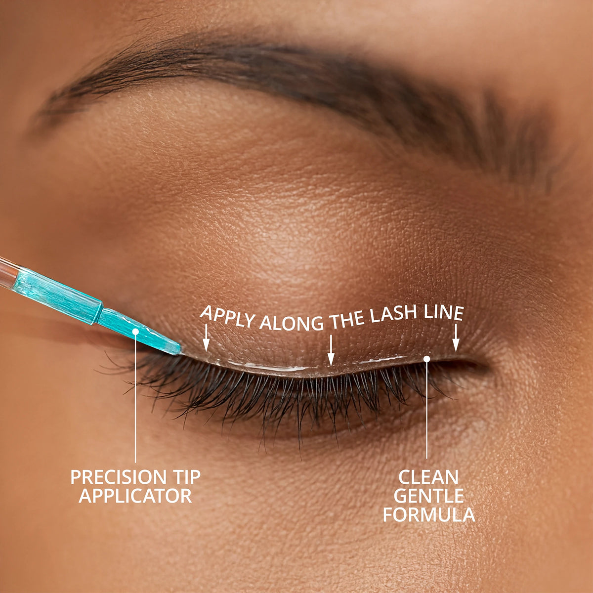 Close-up showing the SugarbearPRO LashCare Serum precision-tip applicator applying serum along the upper lash line.